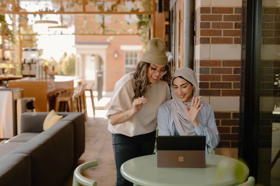 a woman sitting at the table using a laptop
